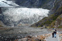 MOUNT COOK NATIONAL PARK  A COUPLE WALK TO THE TERMINAL FACE OF THE FRANZ JOSEF GLACIER. Julius von Haast  geologist and explorer  named Franz Josef Glacier in 1863  after the Emperor of the Austro-Hu...