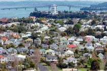 GENERAL VIEW OF THE RESIDENTIAL DISTRICT OF DEVENPORT IN THE FOREGROUND AND ON TO STANLEY POINT AND AUCKLANDS HARBOUR BRIDGE CARRYING ROUTE 1 MOTORWAY CROSSING WAITEMATA HARBOUR IN THE DISTANCE.Antip...