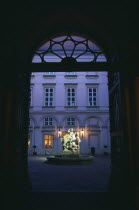 Primacialny or Primate s Palace.  Inner arcaded courtyard with fountain with statue of St George and the dragon at its centre framed by archway.