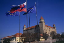 Flags flying outside Bratislava Castle  reconstructed 1956-68 after burning down.  Part of the compound continues to be used by the Slovak Parliament.