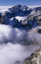 View over snowy peaks of the High Tatras mountains above drifting cloud from the Lomnicky Stit viewpoint.