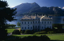 Bellagio.  Neo-classical exterior of the Villa Melzi built by architect Giocondo Albertolli 1808-10 as a Summer residence for Francesio Melzi.  Lake and mountains behind