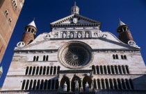 Piazza del Comune.  Part view of exterior facade of the Duomo with thirteenth century rose window and portico with statues of the Virgin and saints.