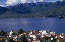 Stresa.  View over red tiled rooftops of town towards lake and mountain backdrop from Monte Mottarone.