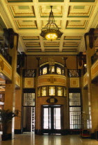 China, Shanghai Peace Hotel, Interior of foyer with marble floor,  upper balcony and revolving door at entrance.