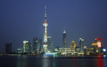 Pudong at night with illuminated skyscrapers and buildings including the Oriental Pearl Tower and Jin Mao Building.