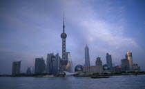 Pudong skyline at dusk with skyscrapers including the Oriental Pearl Tower and the Jin Mao Building.