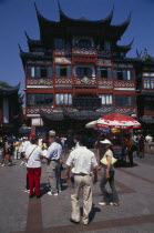 Yu Gardens street scene with shoppers  tourists  shops and souvenir stalls.