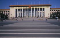 Tiananmen Square.  Great Hall of the People  venue of the National people s Congress with visitors in queue on steps to entrance and other crossing square in foreground.