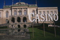 Klessheim Palace  now the Salzburg Casino.  Baroque exterior dating from 18th c. and designed by architect Fischer von Erlach.  Lake  statue and sign for Casino.