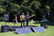 Guitar festival performers with solar powered amplifier systems.