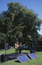 Guitar festival performers with solar powered amplifier systems.