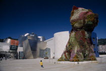 Guggenheim museum with Jeff Koons Puppy sculpture, a forty-three foot tall topiary sculpture of a West Highland White Terrier, in the foreground.