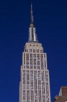 Part view of the Empire State Building from East 34th Street.  Art Deco  steel framed building with radio and TV mast completed in 1931. Designed by architect William Lamb of Shreve  Lamb and Harmon...