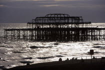 Monochromatic silhouette of remains of West Pier at sunset