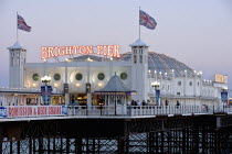 Close-up of Brighton Pier at sunset  showing the illuminated signs