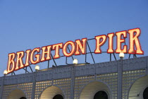 Close-up of illuminated Brighton Pier sign just after dusk