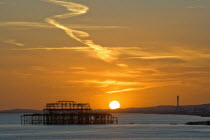 Dramatic orangy-red sunset silhouetting the remains of the West Pier