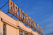 Close-up of illuminated Brighton Pier sign at dusk