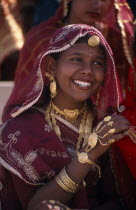 Portrait of a young girl dancer smiling wearing traditional jewellery at the Camel Festival