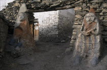 Male and female Animistic protector guardians by the entrance gateway to Jharkot.