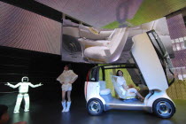 2007 Tokyo Car Show  Honda exhibit  Asimo Robot presents the Honda concept car Puyo  young women assist  cars gull wing doors open