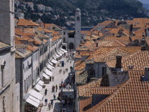 Elevated view over terracotta tiled rooftops and Stradun  the main street in the Old City which is lined with cafes and bars leading towards The Franciscan Monastery Church.