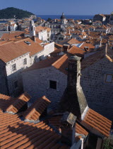 Elevated view over terracotta roof tops towards the Cathedral  St Blaise s Church and clock tower in morning light.