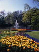 Keukenhof Gardens. Fountain in the parks lake surrounded by colourful tulip displays