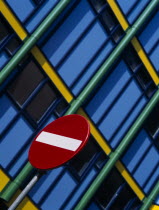 Detail of No Entry road sign with modern colourful apartments behind. Near Zuiderkerk Church