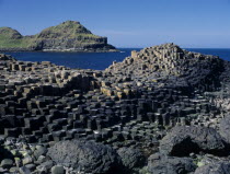 Interlocking basalt stone columns left by volcanic eruptions. View across the main and most  visited section of the causeway with the coastline seen behind.