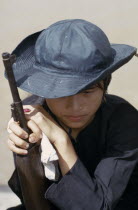 Civil Defence girl soldier leaning on gun.Asian Defense One individual Solo Lone Solitary Southeast Asia Viet Nam Vietnamese 1 History Single unitary Southern