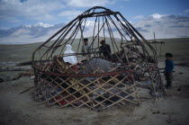 Kirghiz people erecting frame for yurt.