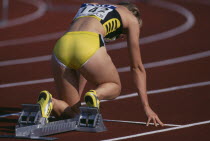 Female runner at starting blocks