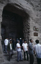 Yungang Caves.  Chinese visitors at cave entrance in ancient Buddhist site containing carvings dating from AD 386 - 534.