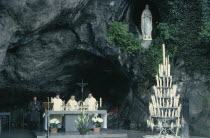 Lourdes.  Priests conducting service at cave shrine in pilgrimage centre.