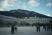 Royal Monastery of San Lorenzo de el Escorial.  Sixteenth century palace and monastery built during the reign of Phillip II.  Exterior with tourist visitors in foreground.