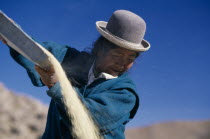 Salar de Uyuni  Manica Town.  Woman winnowing quinoa.