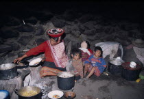 Cancha Cancha. Quechuan Indian family cooking inside their house.