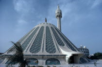 Exterior of modern conical shaped mosque and minaret.
