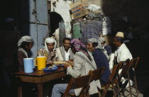 Group of men eating breakfast together.