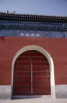 Temple of Heaven.  Detail of gateway set into red painted wall with decorative blue tiling above.