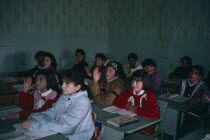 Pupils at desk in school classroom.