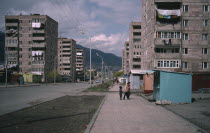 Children on street beside residential flats.