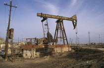 Nodding Donkey oil derrick on industrial site near Baku.