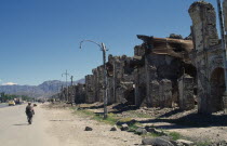 Badly damaged housing lining street.