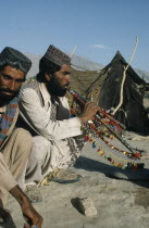 Afghan man playing traditional pipes.