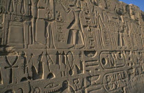 Precinct of Amun.  Detail of relief carving and hieroglyphics along wall of building.