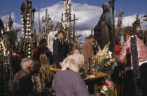 People praying at ancient pilgrimage site near Siaulial.
