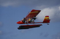 Two seat microlight airborne carrying a tourist